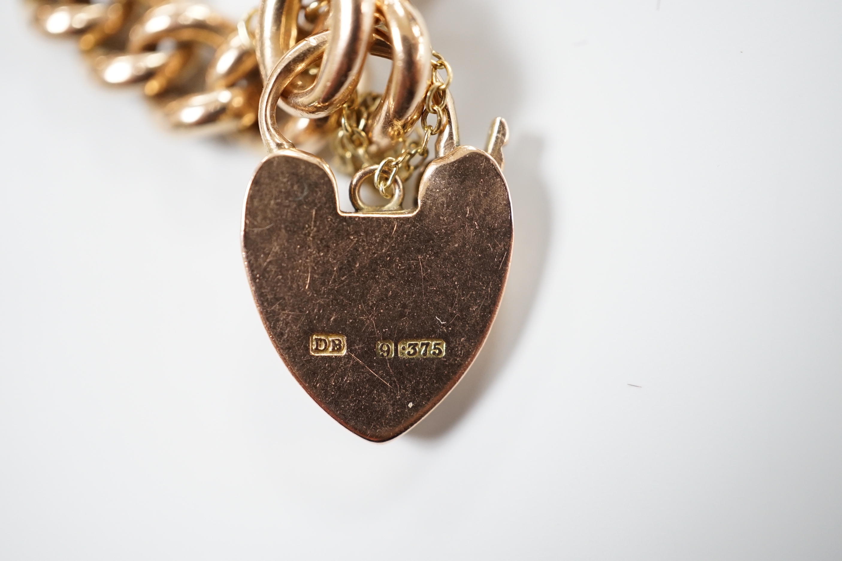 A 9ct gold curb link bracelet, with heart shaped padlock clasp, 18cm